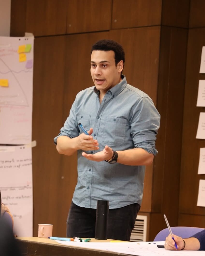 Sakr explaining at a workshop