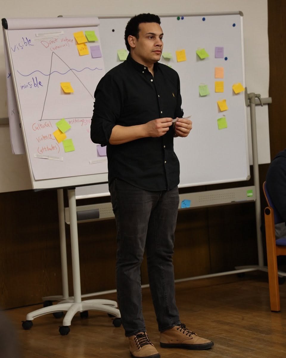 Sakr training in front of a whiteboard on conflict analysis
